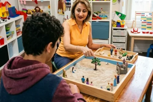 Child and Youth Therapist Shiva Movafaghian guiding a child through sand tray play therapy for trauma at Alpha Child Therapy, Richmond Hill