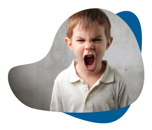 Young boy shouting angrily, representing emotional regulation and anger management therapy for children.