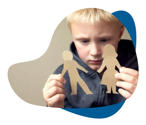 Sad boy holding separated cardboard cutouts of parents, symbolizing parental divorce