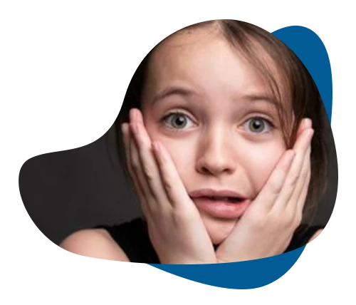 Frightened young girl with hands on her cheeks, representing fear and phobias in children.