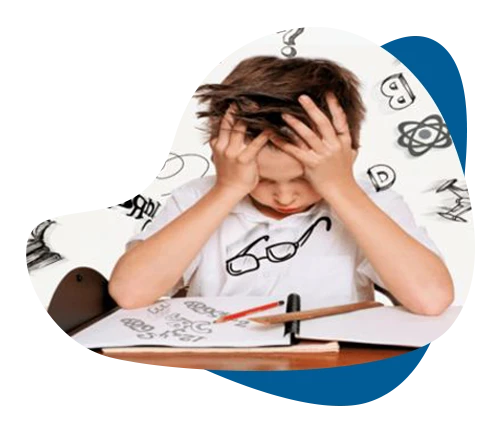 Frustrated boy holding his head over open notebook, illustrating a child struggling with a learning disorder.