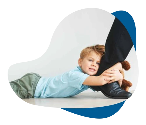 Child clinging to parent's leg, showing separation anxiety addressed through therapy in Richmond Hill.