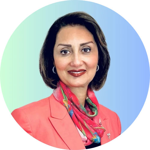 Therapist at Alpha Child Therapy smiling in a coral blazer and colorful floral scarf