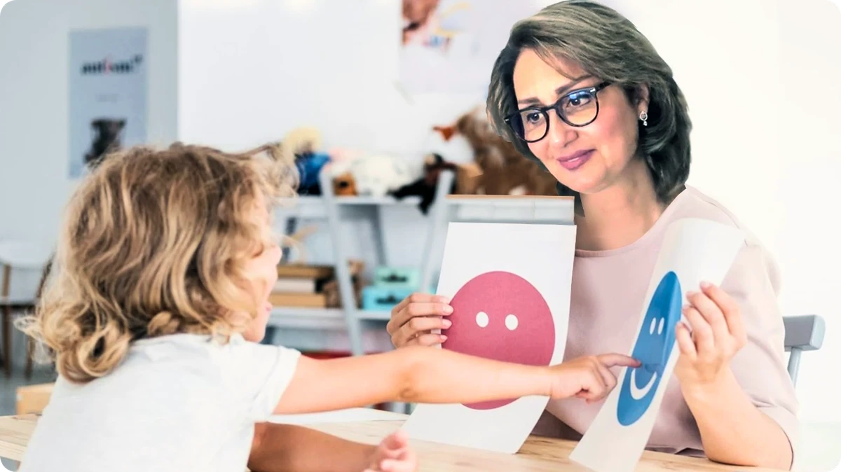 Child therapist using emotion flashcards with a young child during a play therapy session.